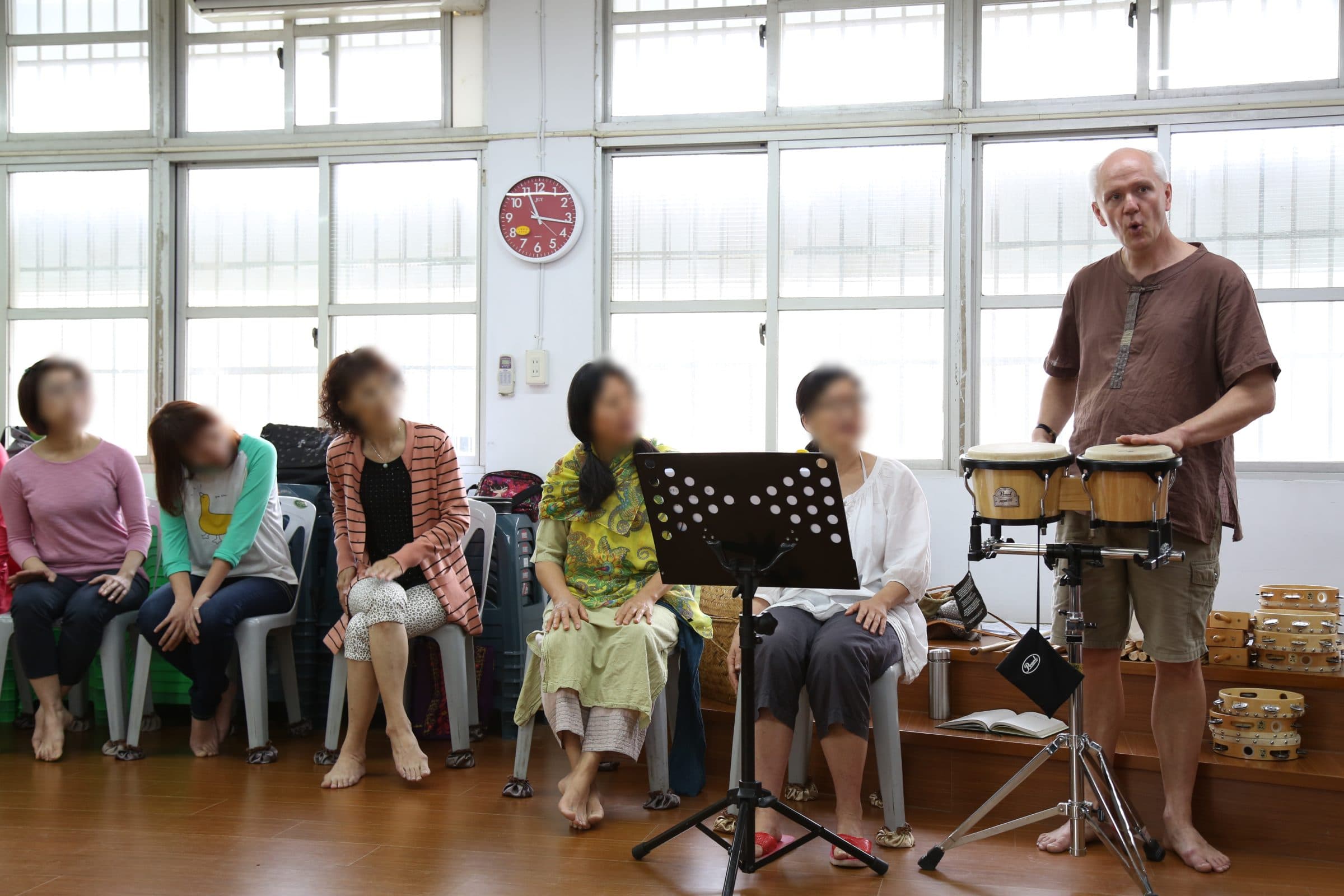 Markus Weiss playing congas for seated workshop participants