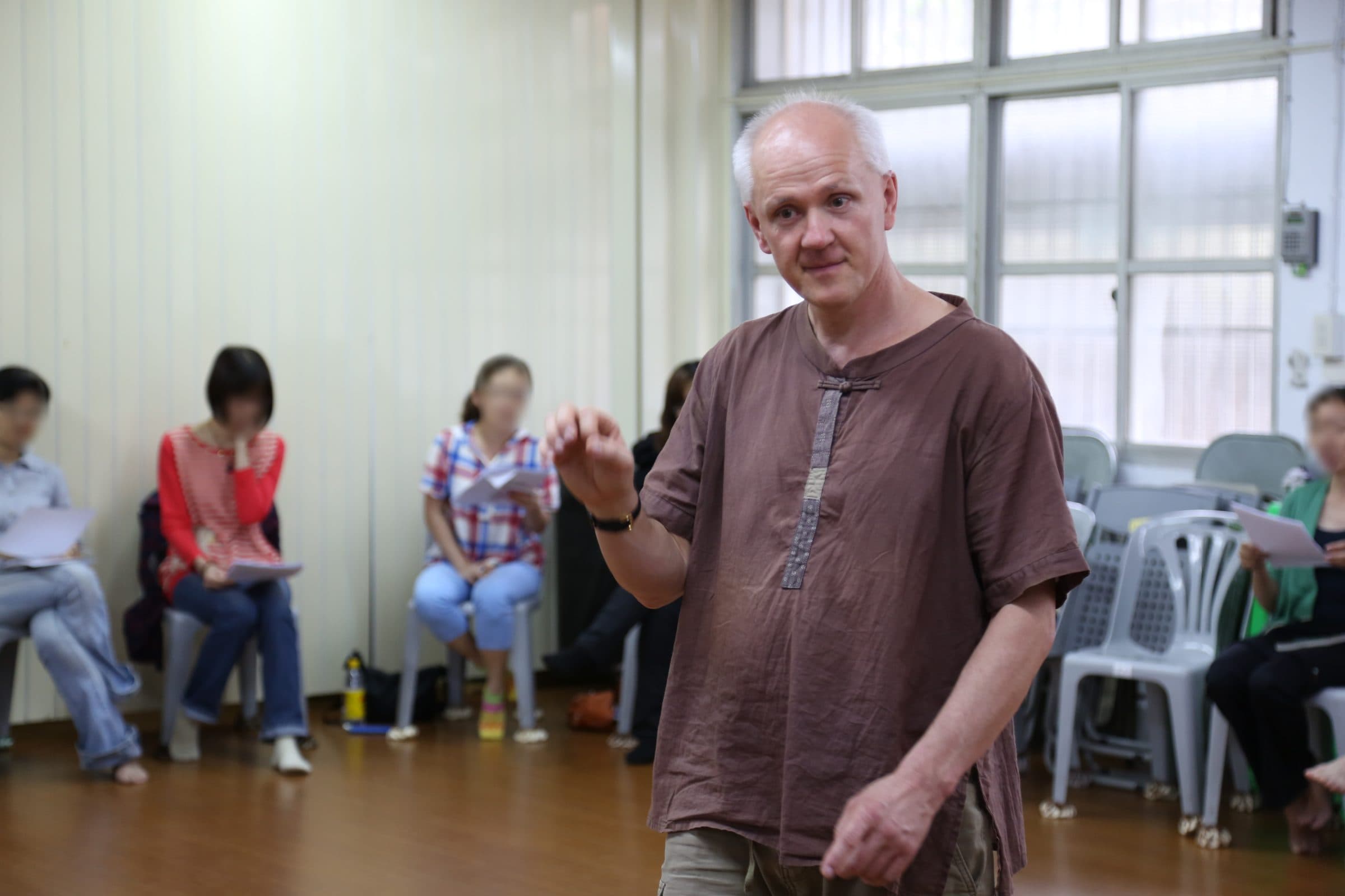 Markus Weiss speaking to workshop participants holding sheet music